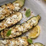 Grilled Zucchini Boats: A Flavorful Twist on a Classic 4 Grilled zucchini boats on the grill with fresh ingredients.