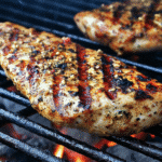 Grilled Chicken Platter: A Perfect Meal for Any Occasion 4 Grilling chicken breasts on a BBQ grill with vegetables.