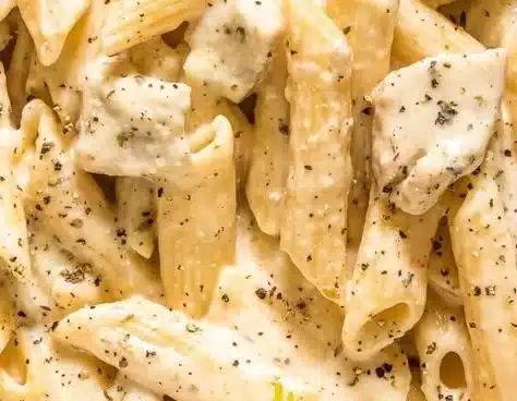 Delicious Cheesy Chicken Pasta garnished with herbs and vegetables