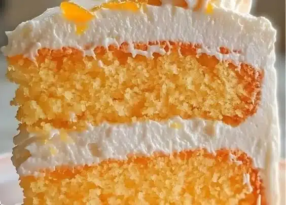 Orange Creamsicle Cake Recipe 3 Slice of homemade Orange Creamsicle Cake on a white plate