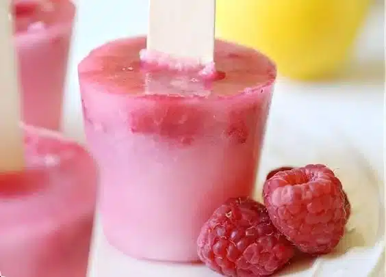 Raspberry Lemonade Popsicles Recipe 3 Delicious homemade Raspberry Lemonade Popsicles on a summer day