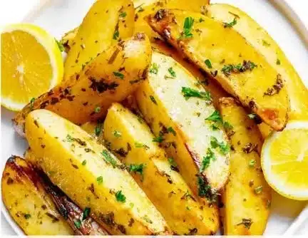 Delicious roasted Greek lemon potatoes garnished with herbs