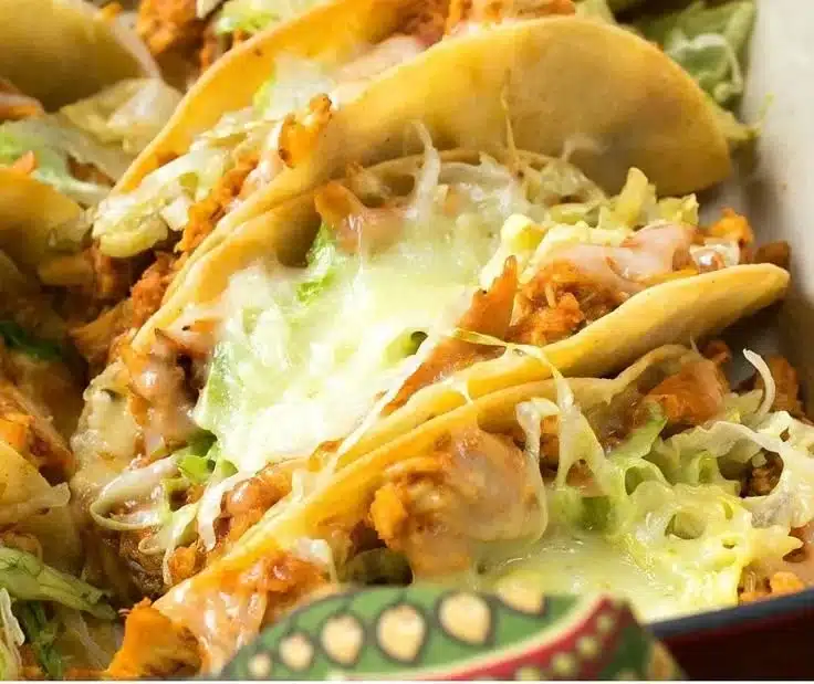 Delicious rotisserie chicken tacos served in a colorful platter for a weeknight meal.