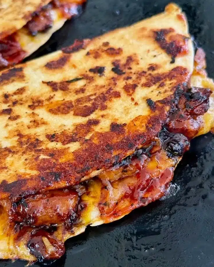 Blackstone Hot Honey BBQ Chicken Quesadillas served on a wooden board