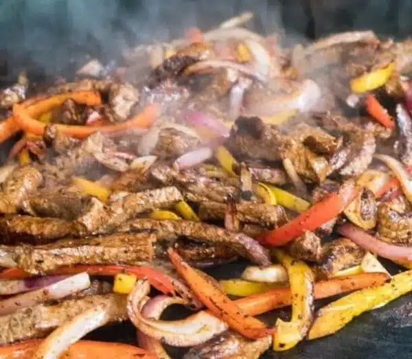 Blackstone Steak Fajitas 3 Delicious Blackstone steak fajitas sizzling on the grill
