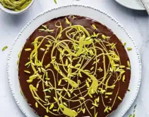 Delicious slice of Dubai Chocolate Cake with chocolate drizzle and fresh berries