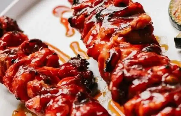 Grilled BBQ Chicken Thighs - Filipino Style 3 Grilled BBQ Chicken Thighs Filipino style, garnished with herbs and spices