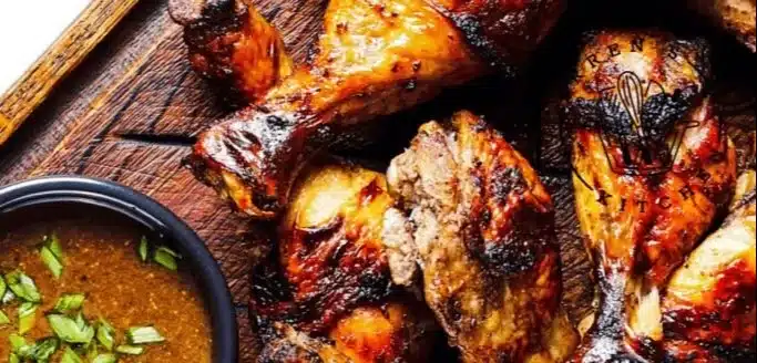 Delicious grilled chicken thighs and legs on a BBQ grill