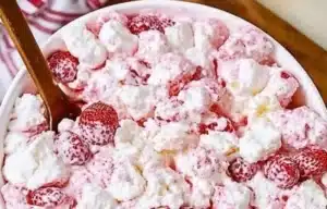 Strawberry Shortcake Fluff Salad in a bowl, topped with fresh strawberries