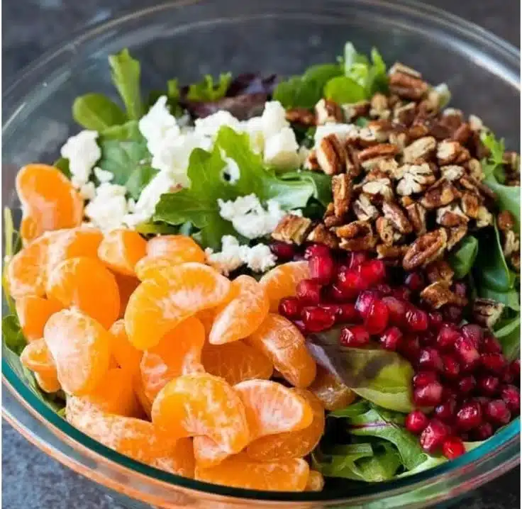 Colorful winter salad with seasonal ingredients and fresh greens