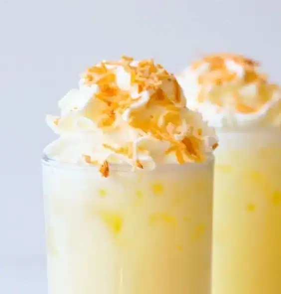 Coconut Pineapple Italian Soda 3 Coconut Pineapple Italian Soda in a glass with ice and tropical garnishes