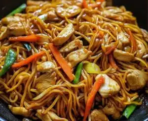 Plate of easy chicken lo mein with vegetables and chicken.