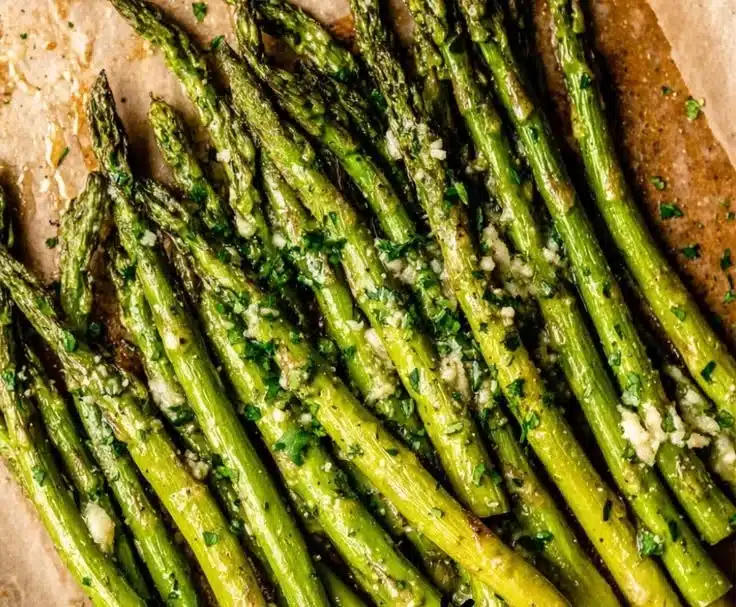 Grilled Asparagus with Garlic Butter 4 Platter of grilled asparagus drizzled with garlic butter sauce.