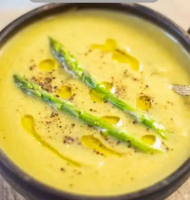 Instant Pot Asparagus Soup 3 Creamy Instant Pot asparagus soup served in a bowl with fresh asparagus garnish