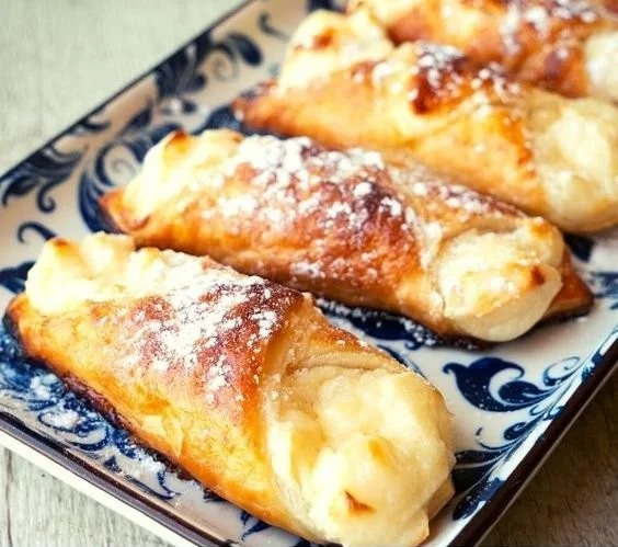 Golden Puerto Rican quesitos filled with cream cheese, a delightful pastry treat.