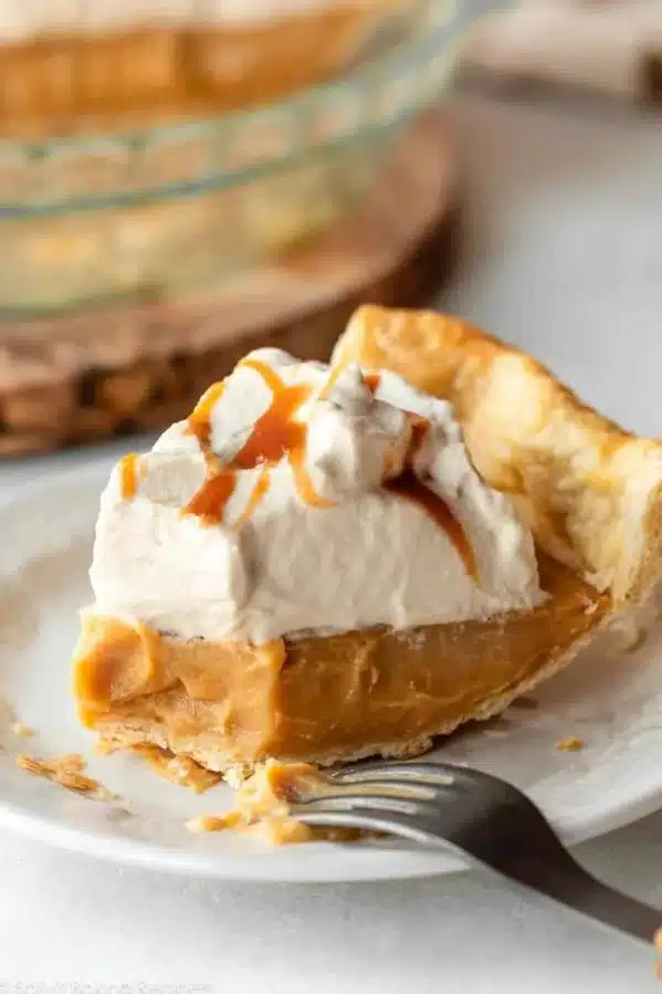 Delicious slice of butterscotch pie topped with whipped cream