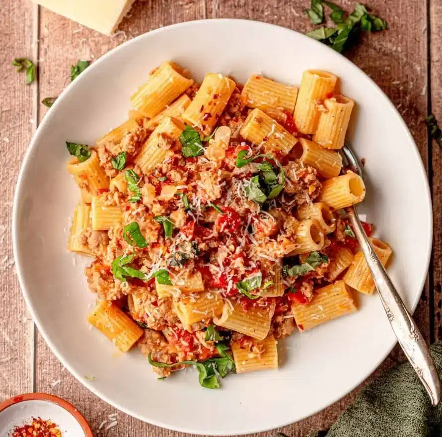A delicious plate of Italian Sausage Pasta served with fresh herbs