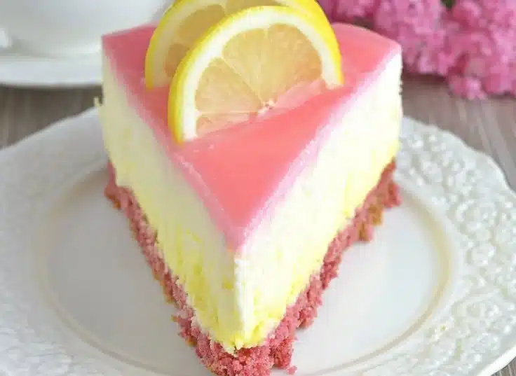 Lemon Cheesecake with Strawberry Crust 4 Lemon Cheesecake with Strawberry Crust slice on a white plate