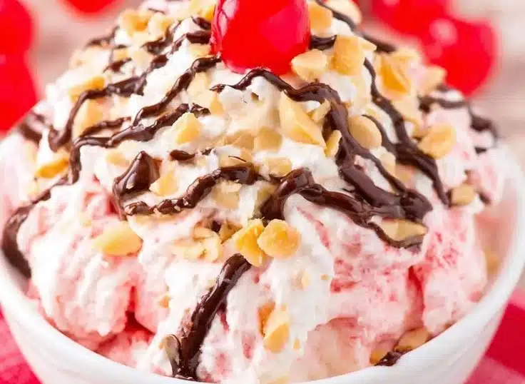 Delicious Banana Split Fluff dessert topped with cherries and whipped cream