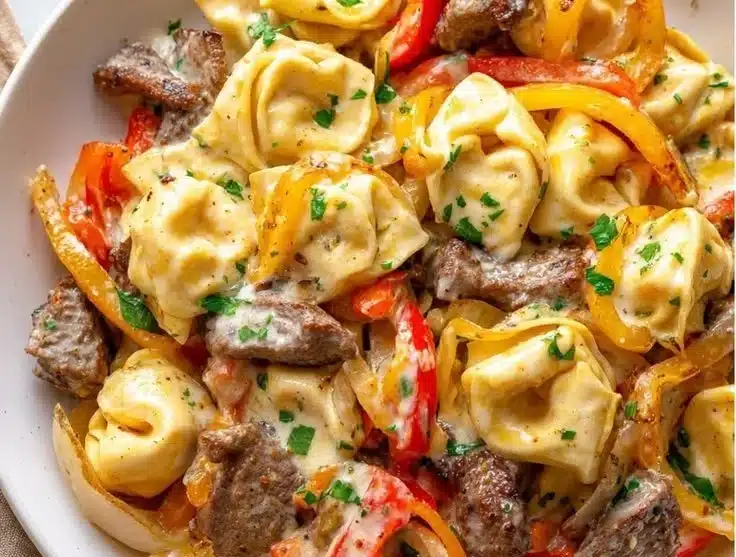 Cheesesteak Tortellini Skillet 6 Cheesesteak tortellini skillet with beef, peppers, and cheese melting together