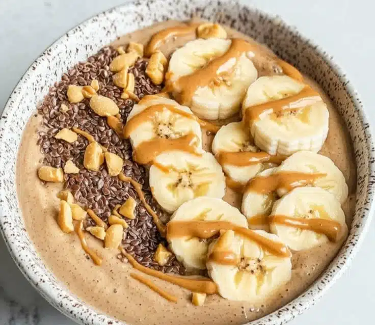 Peanut Butter Banana Smoothie Bowl topped with fresh fruit and nuts