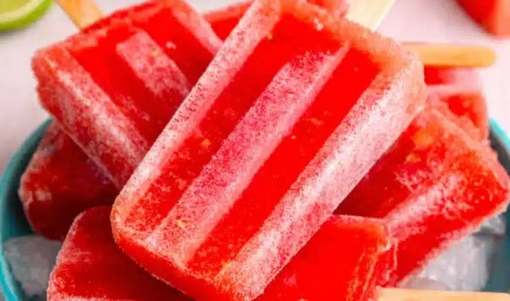 Refreshing watermelon popsicles garnished with mint leaves, perfect summer treat.