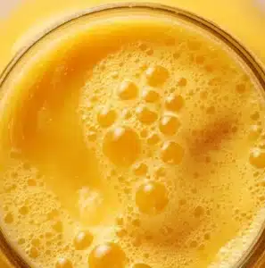A refreshing glass of the world's best mango juice with fresh mango slices