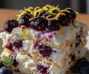 No-bake lemon blueberry icebox cake sliced on a serving plate.