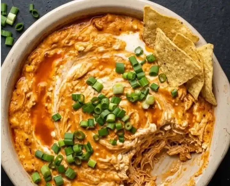 Healthy Buffalo Chicken Dip 2 A bowl of healthy buffalo chicken dip served with fresh vegetables.