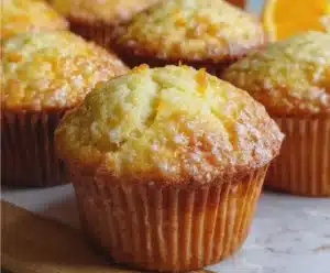 Freshly baked Orange Vanilla Buttermilk Muffins on a rustic table