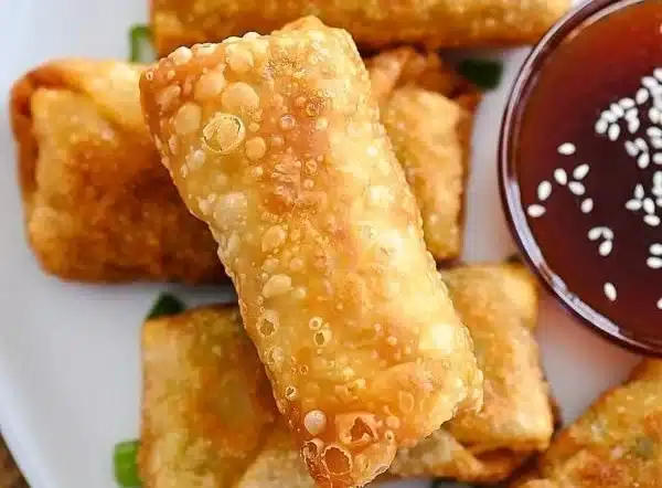 Delicious crispy chicken egg rolls served with homemade sweet and sour sauce