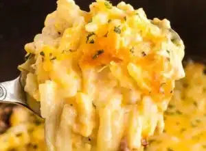 Crock Pot hash brown casserole served in a dish with toppings.
